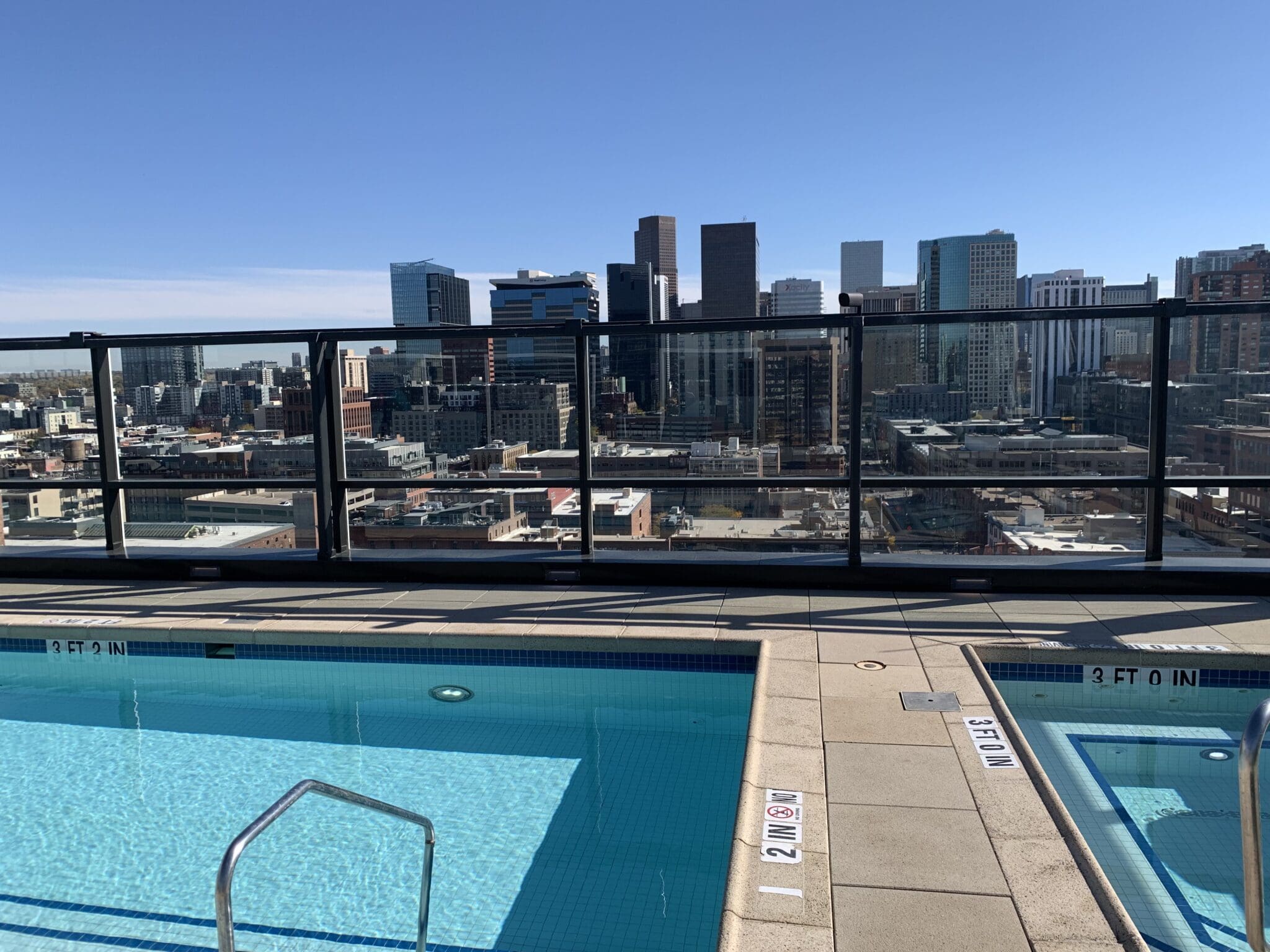 Rooftop pool with city skyline view.