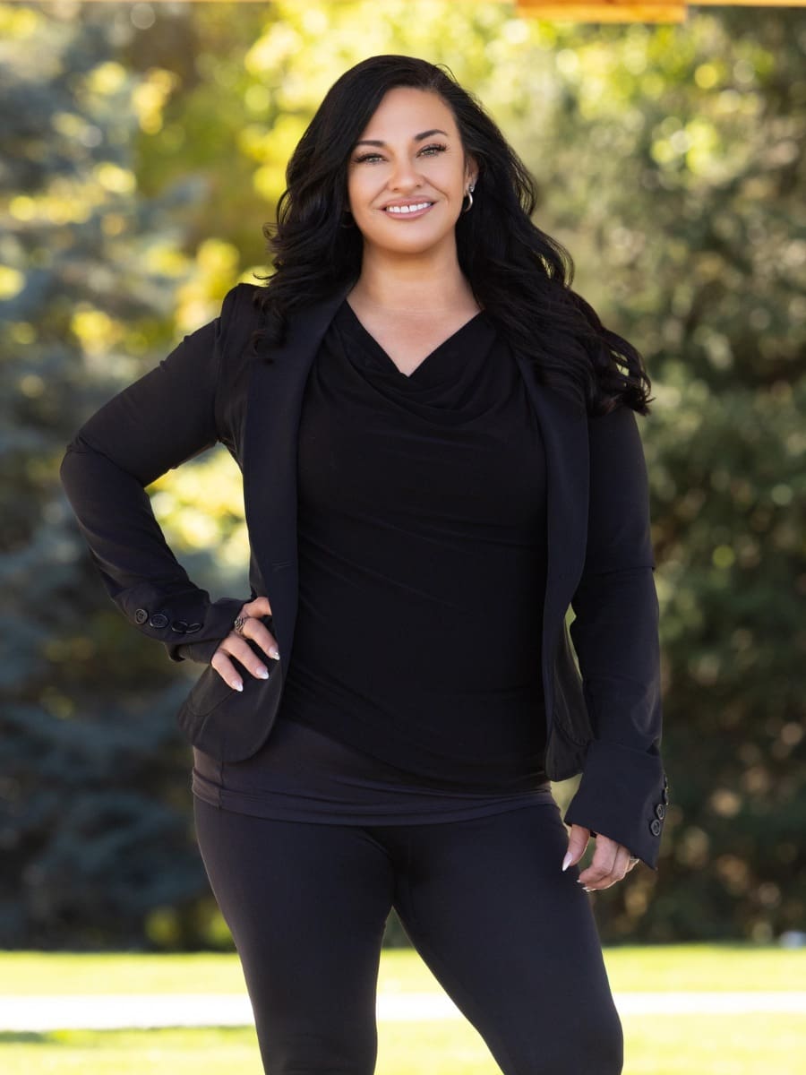 Smiling woman in black outfit outdoors