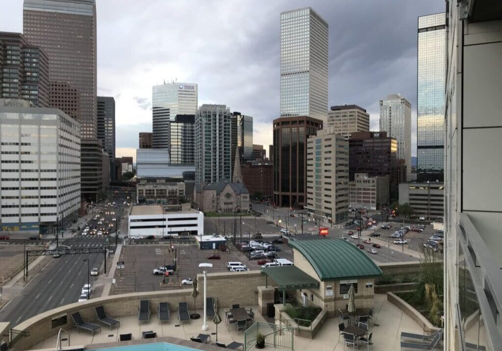 City skyline with pool and cloudy sky.